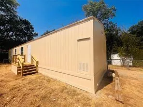 a backyard of a house with trees and slides