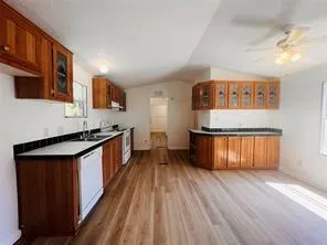 a large kitchen with stainless steel appliances granite countertop a stove and a sink
