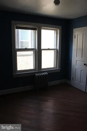 a bathroom with a sink a table and chair