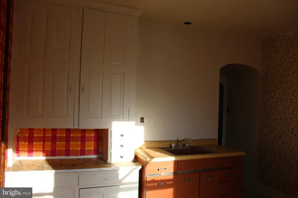 a stove top oven sitting inside of a kitchen