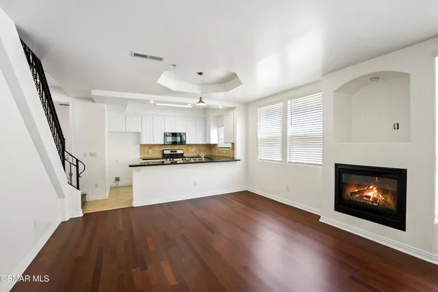 a kitchen with a refrigerator and a fireplace