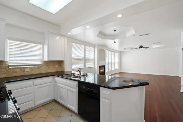 a kitchen with stainless steel appliances granite countertop a sink a stove and cabinets