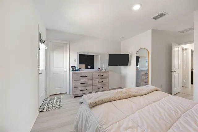 a bedroom with a bed and a flat screen tv