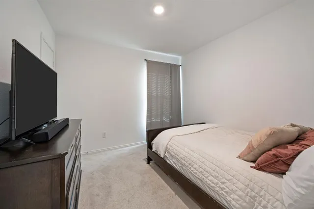 a bedroom with a bed and flat screen tv