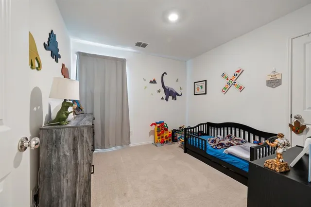 a bedroom with furniture and a window