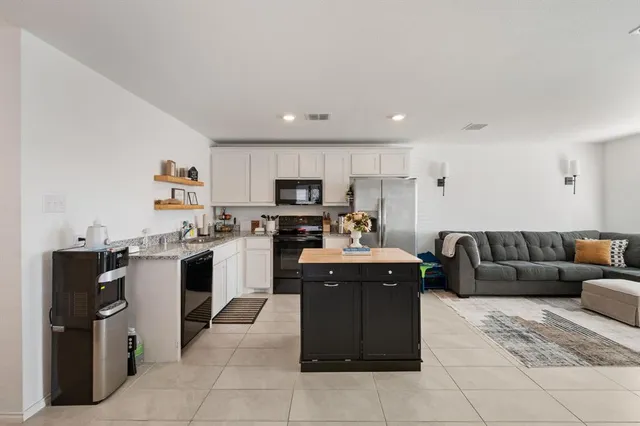 a kitchen with cabinets and refrigerator