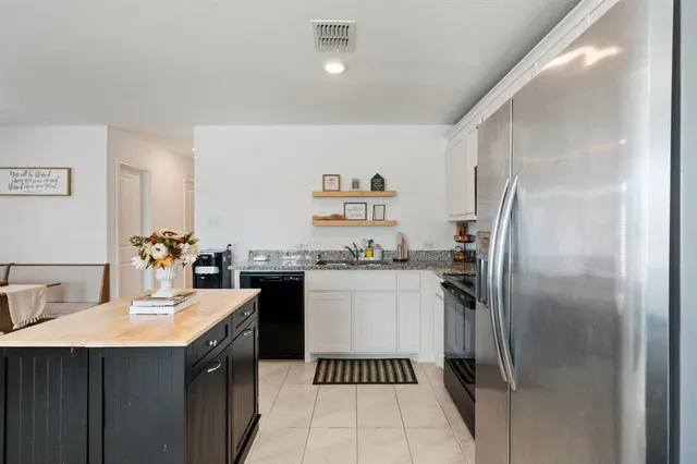 a kitchen with a refrigerator and a sink
