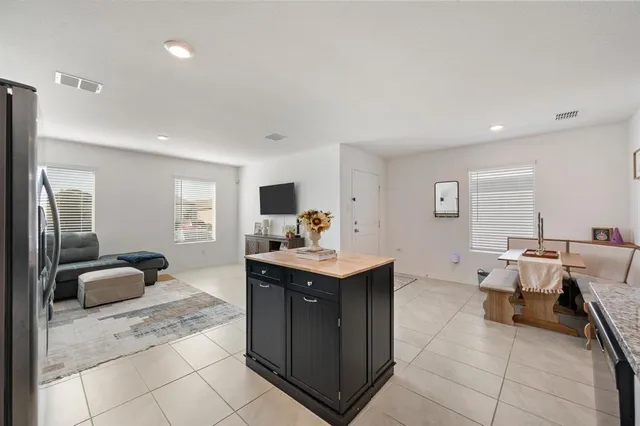 a view of kitchen island a sink wooden floor and living room