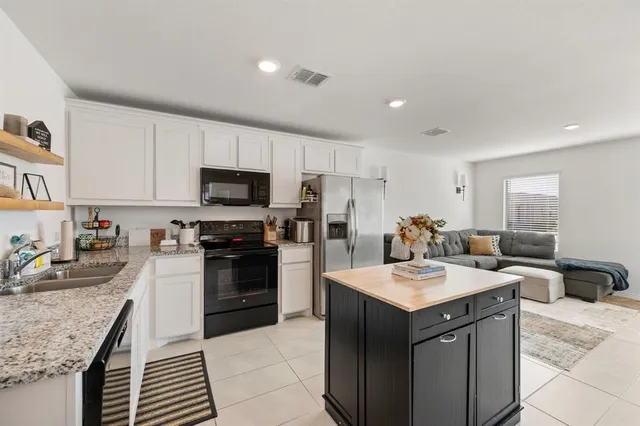 a kitchen with a sink stove and microwave