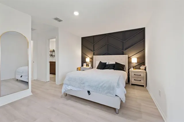 a bedroom with a bed and a walk in closet