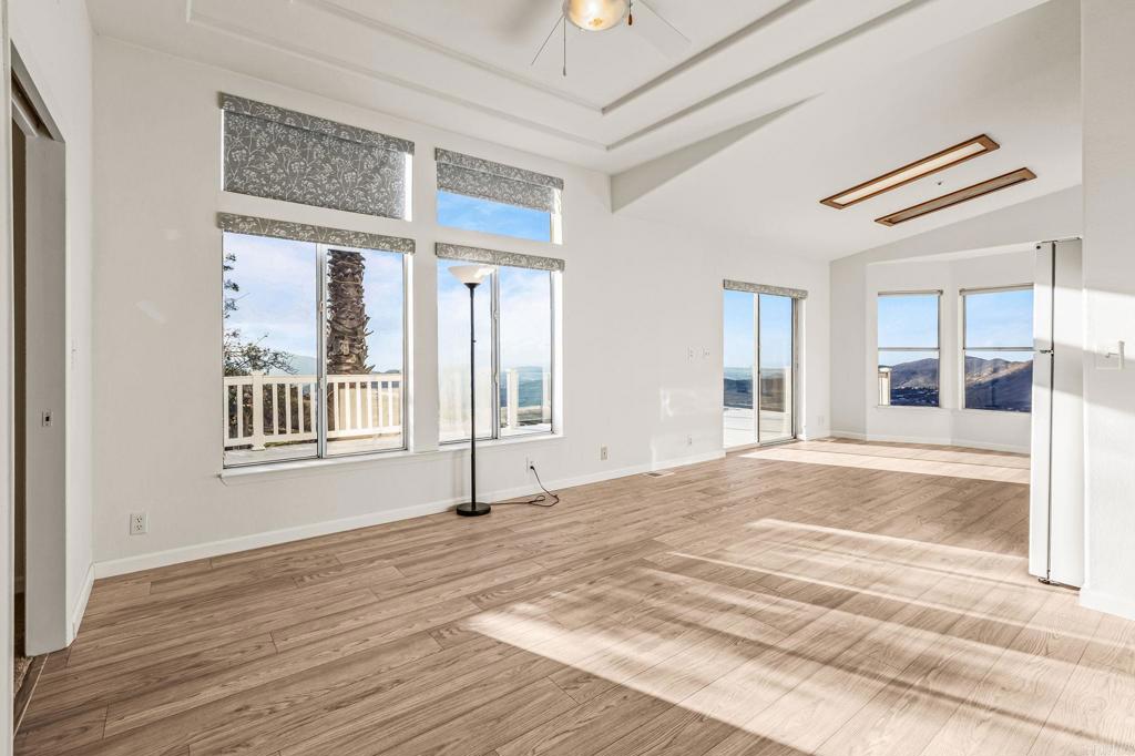 15351 Isla Vista Road Jamul, CA 91935 - Photo 26 of 40 a view of an empty room with wooden floor and a window