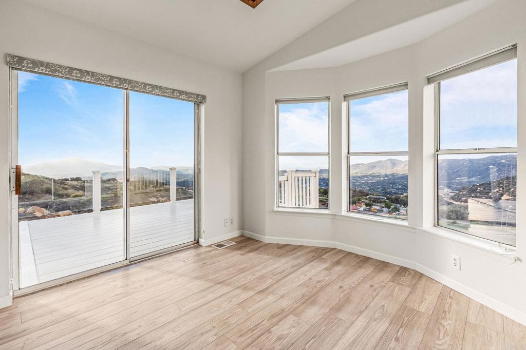 15351 Isla Vista Road Jamul, CA 91935 - Photo 30 of 40 a view of empty room with wooden floor and floor to ceiling window