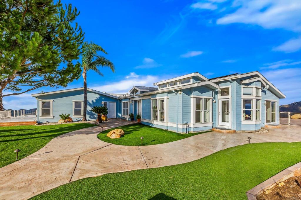 15351 Isla Vista Road Jamul, CA 91935 - Photo 4 of 40 a front view of a house with a garden