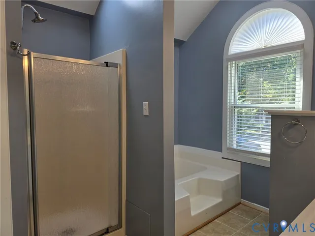 a bathroom with a bathtub and a shower