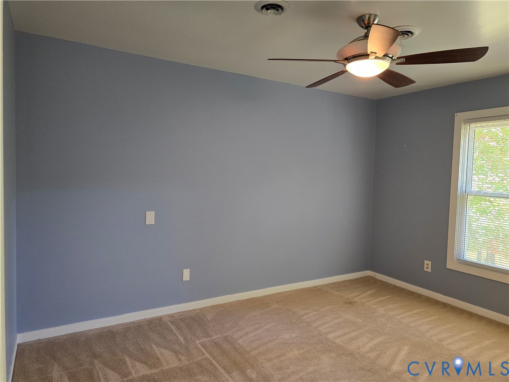 5716 Saddle Hill Drive Midlothian, VA 23112 - Photo 18 of 26 an empty room with a window and a fan