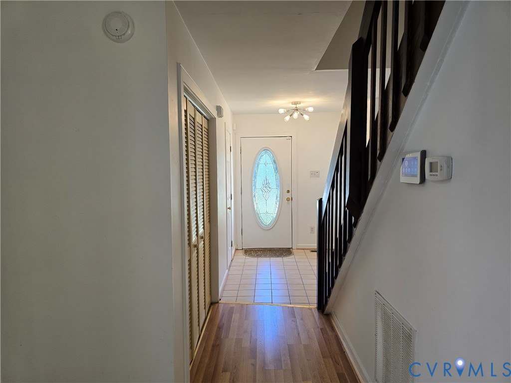 5716 Saddle Hill Drive Midlothian, VA 23112 - Photo 2 of 26 a view of a hallway with wooden floor and staircase