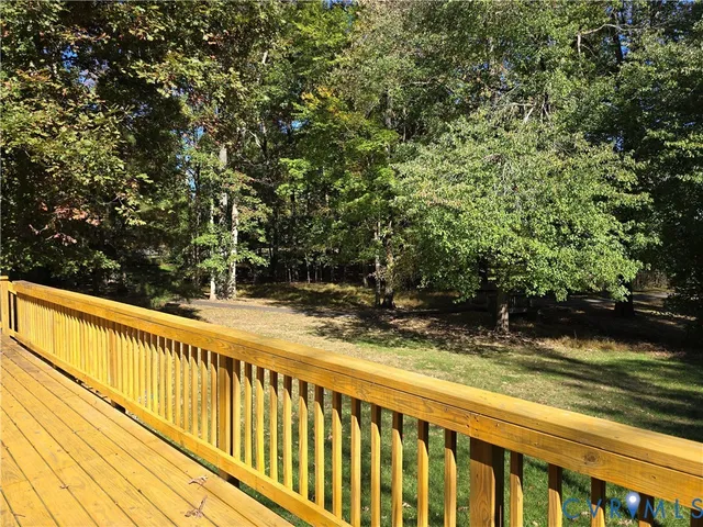 a view of balcony with wooden floor and fence