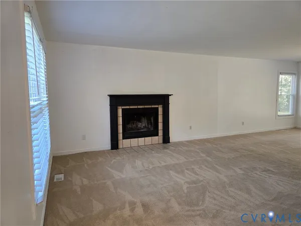 a view of empty room with a fireplace