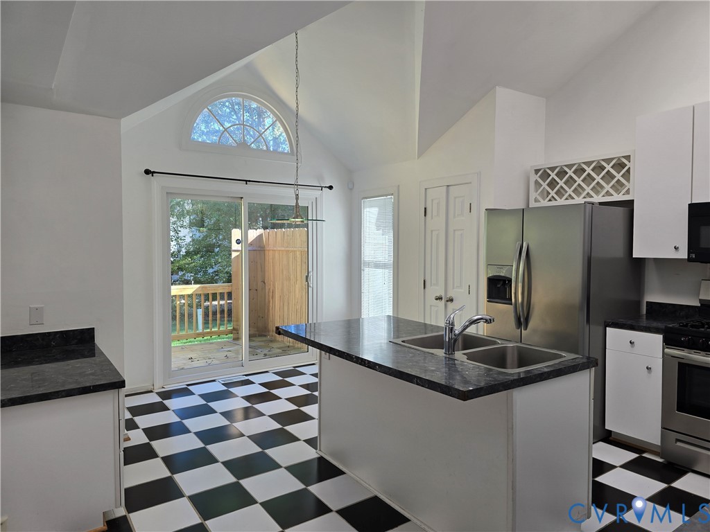 5716 Saddle Hill Drive Midlothian, VA 23112 - Photo 9 of 26 a kitchen with a sink a refrigerator and a stove top oven