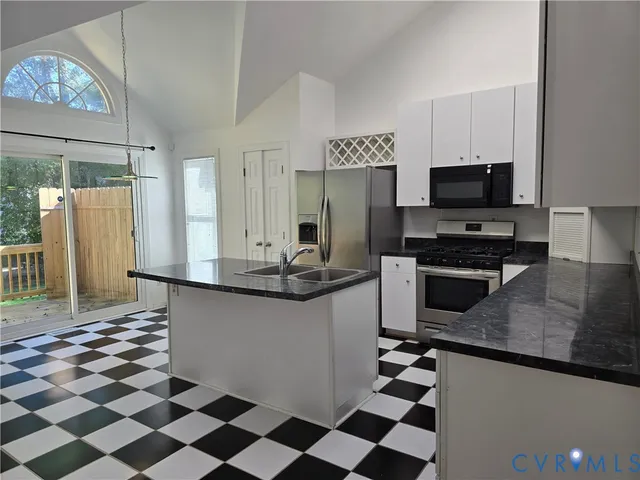 a kitchen with granite countertop a sink and a stove top oven
