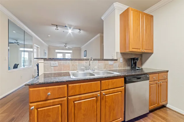 a kitchen with stainless steel appliances granite countertop a stove microwave and sink