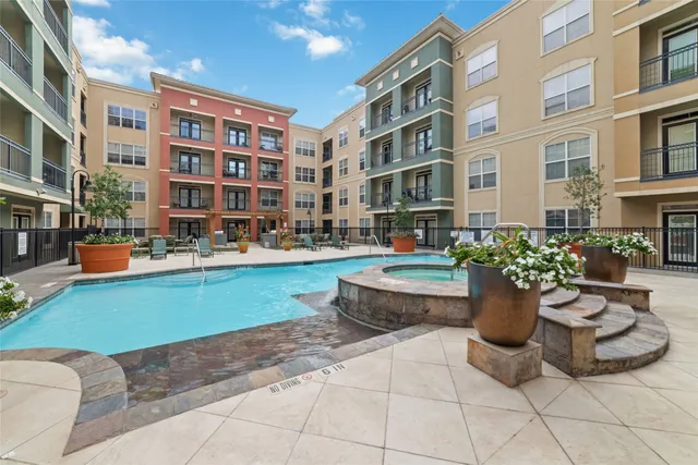 a row of water fountain in front of building