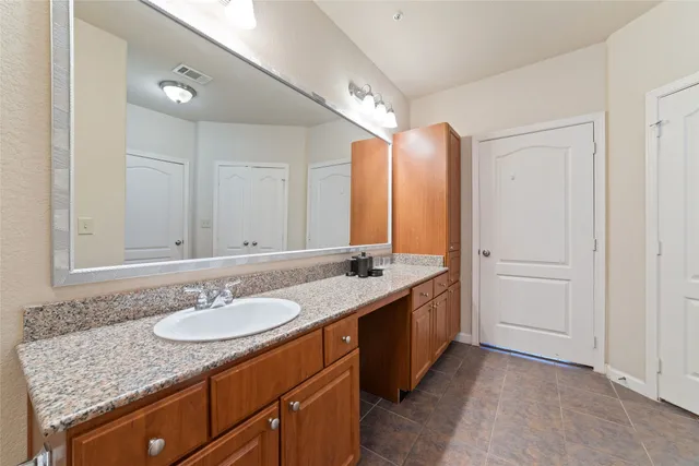 a view of a building with a garden and sitting area