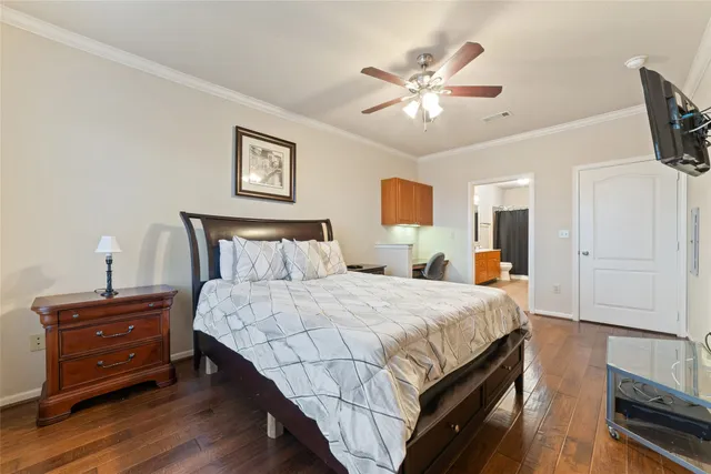 a bedroom with a bed a desk and chair