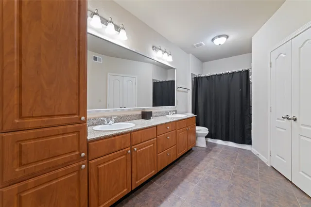 a spacious bathroom with a double vanity sink and a mirror