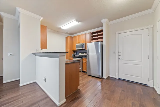 a kitchen with stainless steel appliances granite countertop a refrigerator and a stove