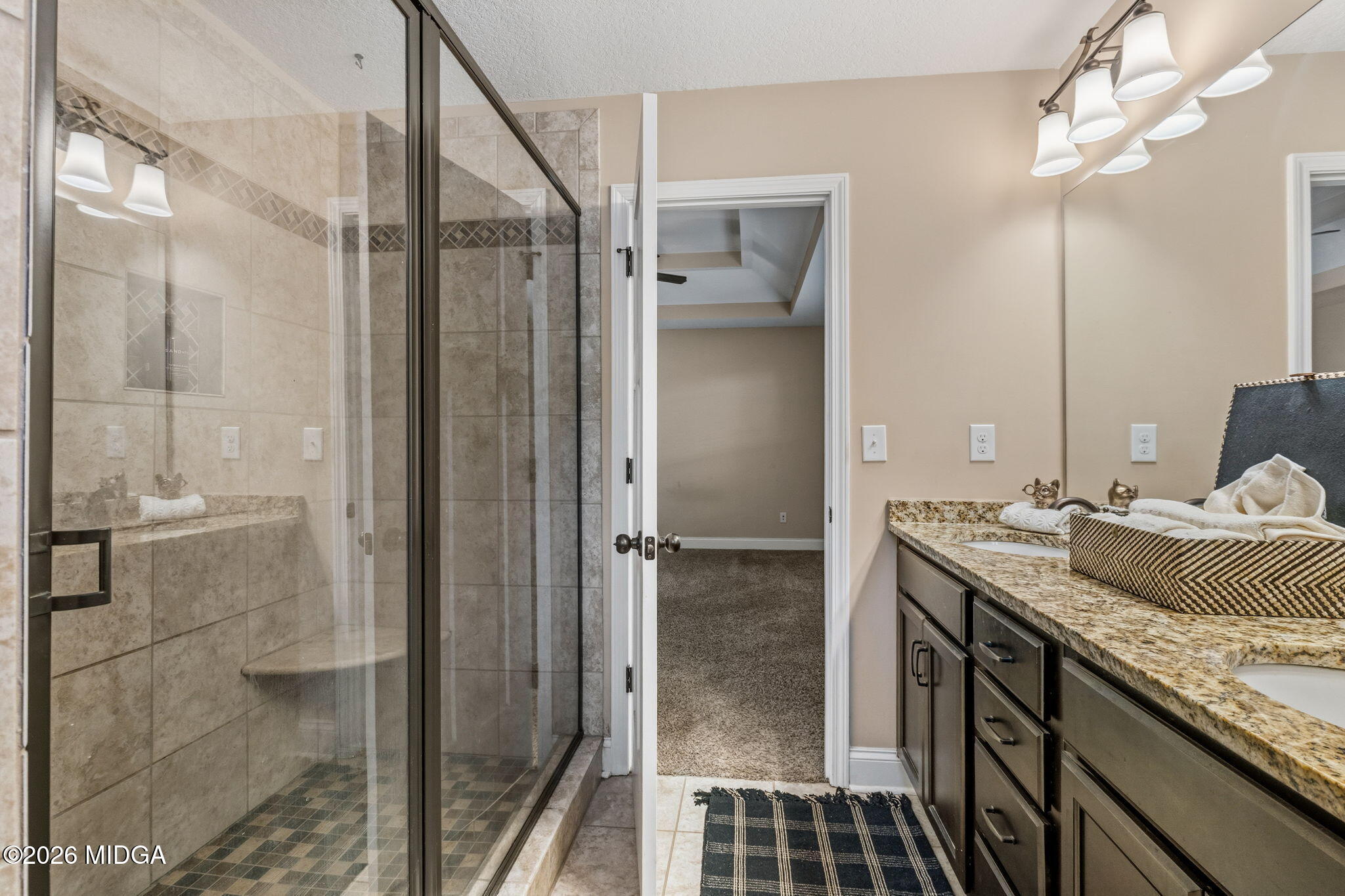 109 Hawks Rdg Trace Byron, GA 31008 - Photo 16 of 26 a bathroom with a granite countertop sink a mirror and shower
