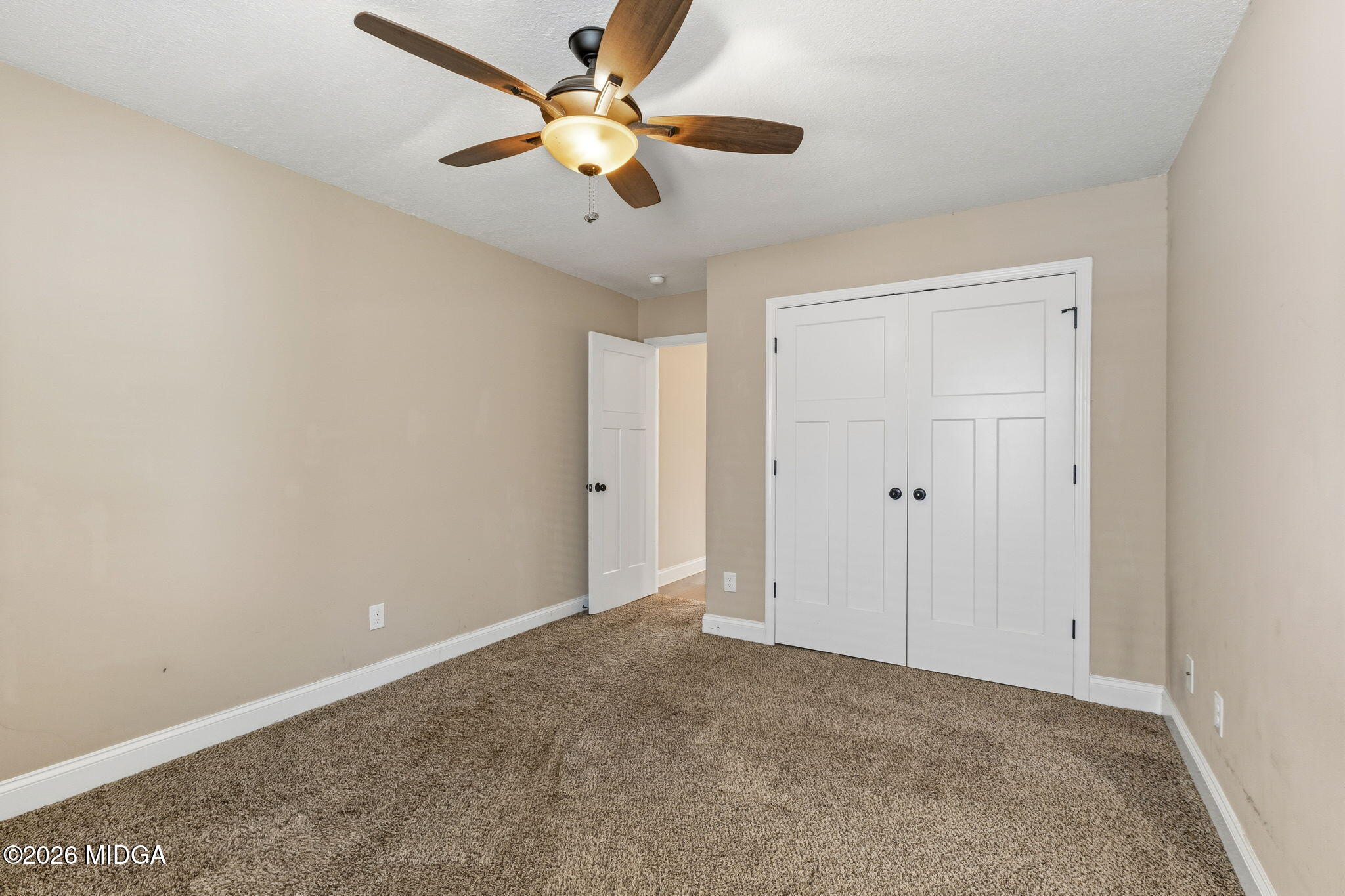 109 Hawks Rdg Trace Byron, GA 31008 - Photo 20 of 26 an empty room with a chandelier fan and windows