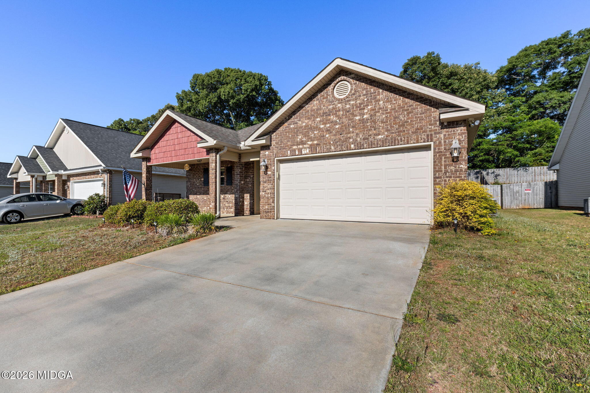 109 Hawks Rdg Trace Byron, GA 31008 - Photo 2 of 26 a front view of a house with a yard and garage