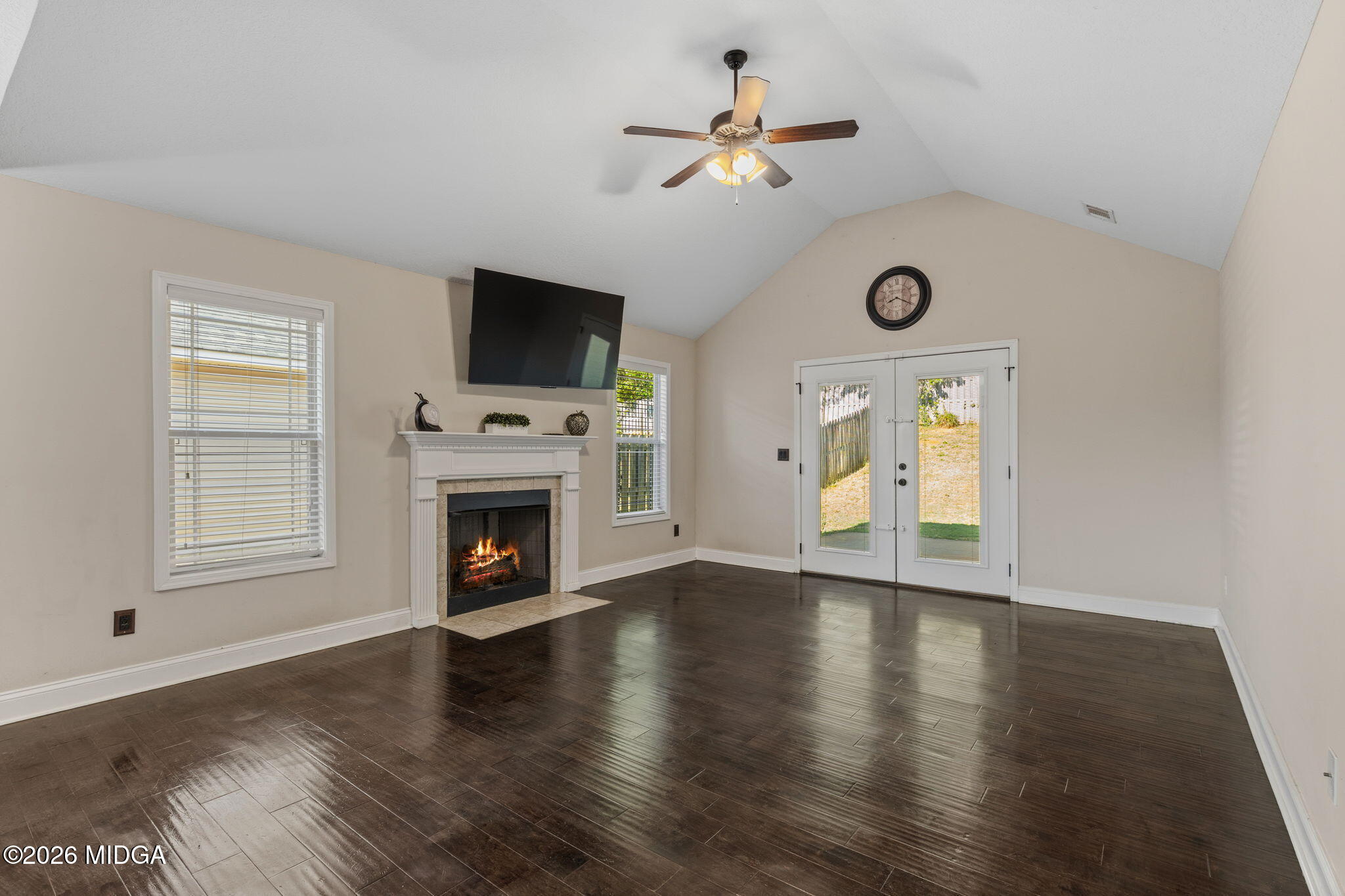 109 Hawks Rdg Trace Byron, GA 31008 - Photo 5 of 26 an empty room with windows fireplace and wooden floor