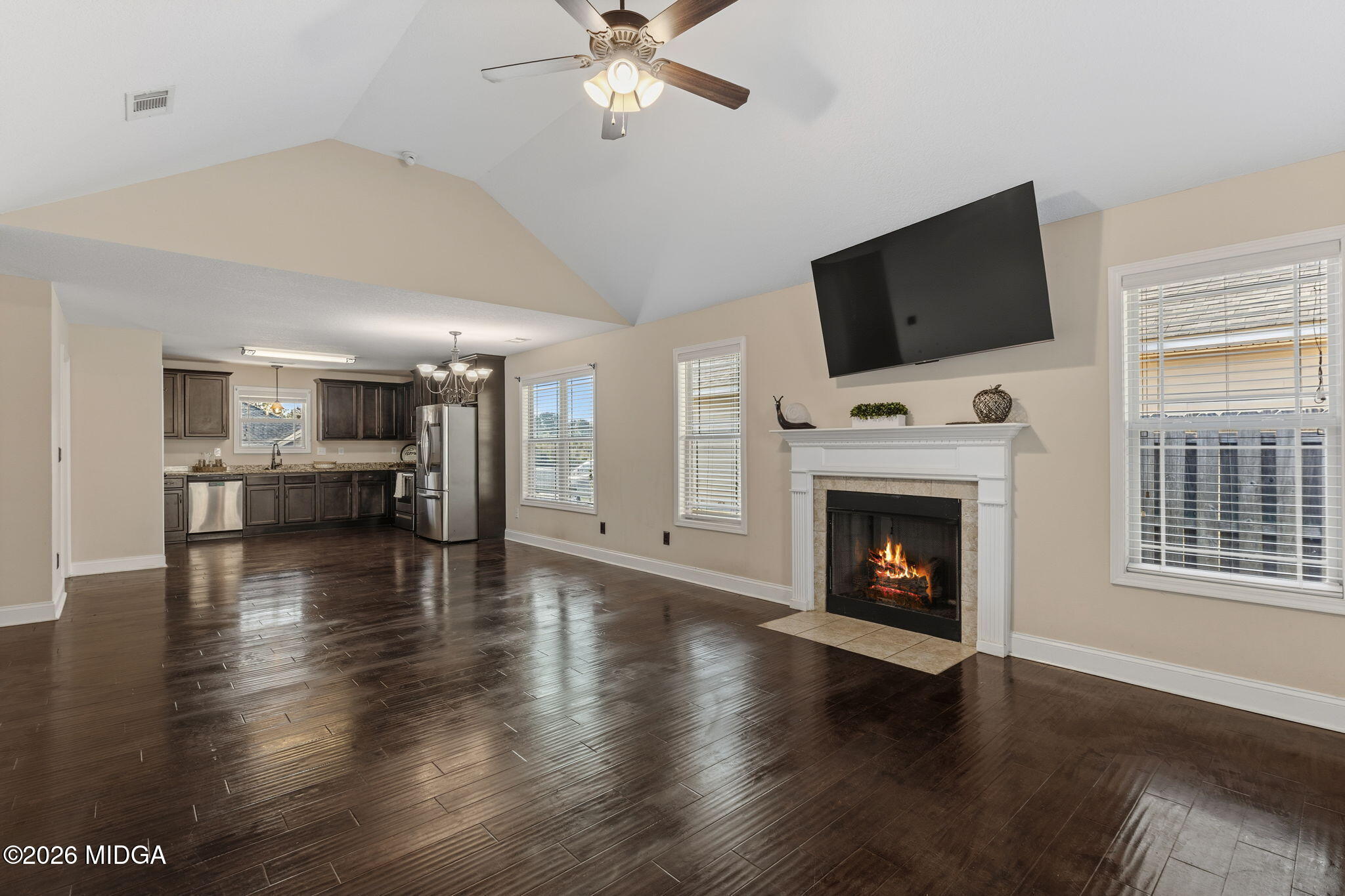 109 Hawks Rdg Trace Byron, GA 31008 - Photo 7 of 26 a view of a livingroom with a fireplace wooden floor and a kitchen