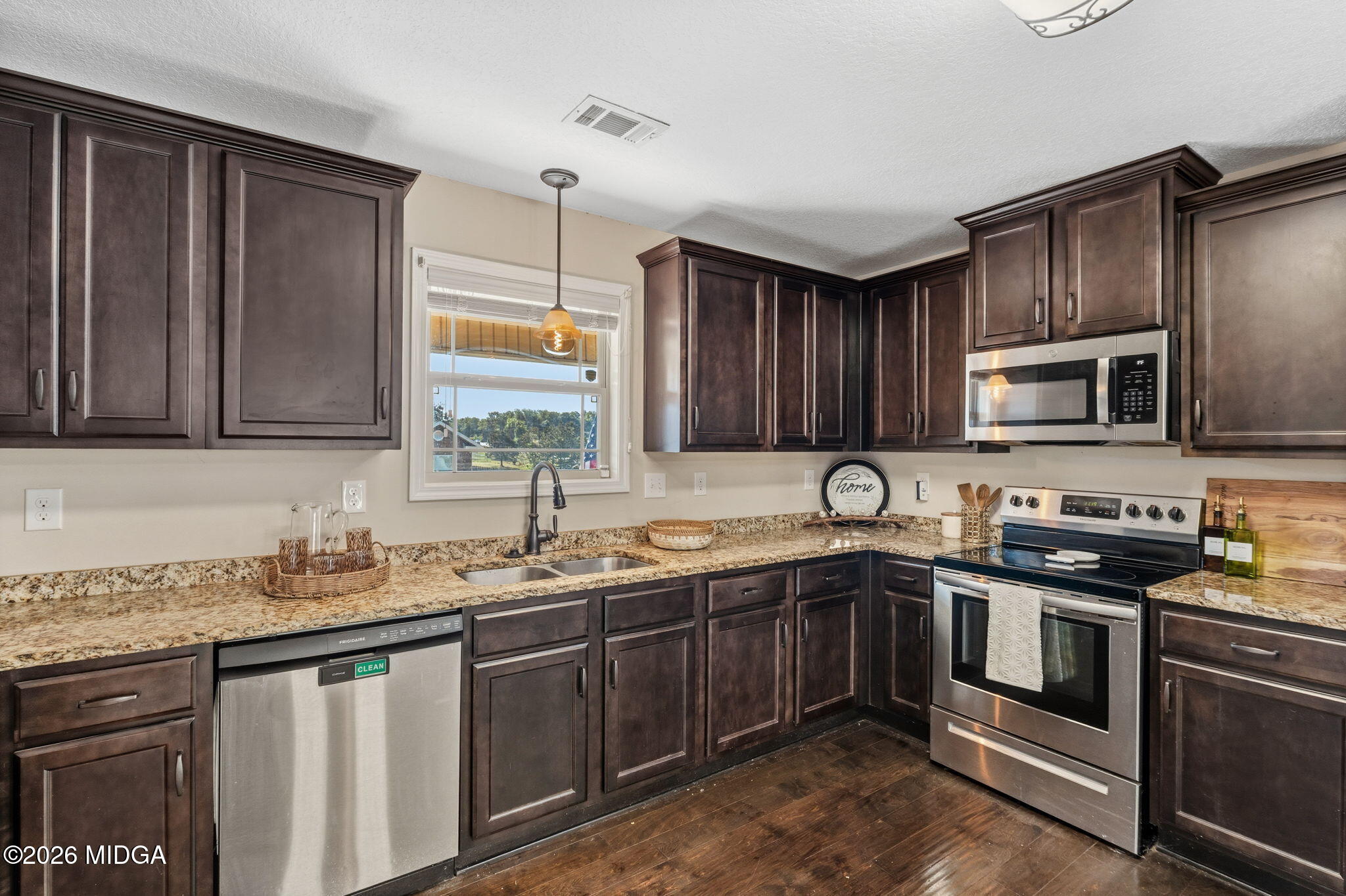 109 Hawks Rdg Trace Byron, GA 31008 - Photo 9 of 26 a kitchen with stainless steel appliances granite countertop a sink stove and microwave