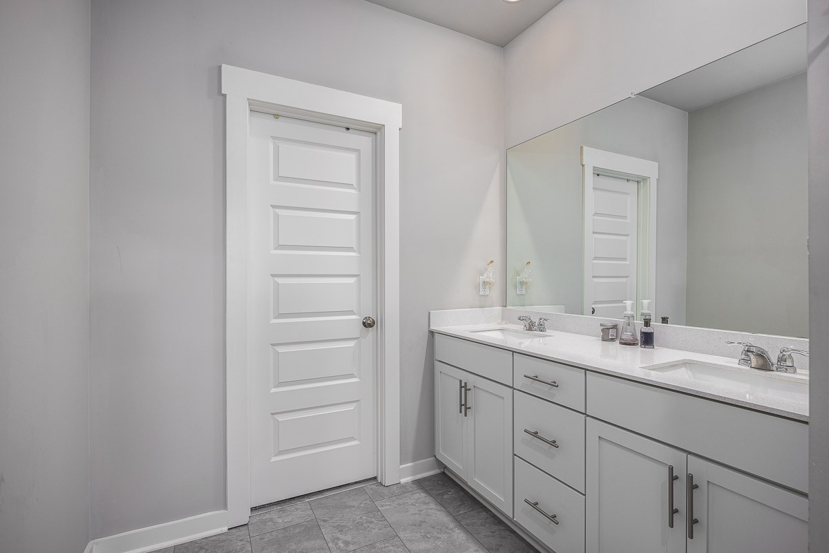 717 Mickelson Way Lebanon, TN 37087 - Photo 12 of 28 a bathroom with a double vanity sink and mirror