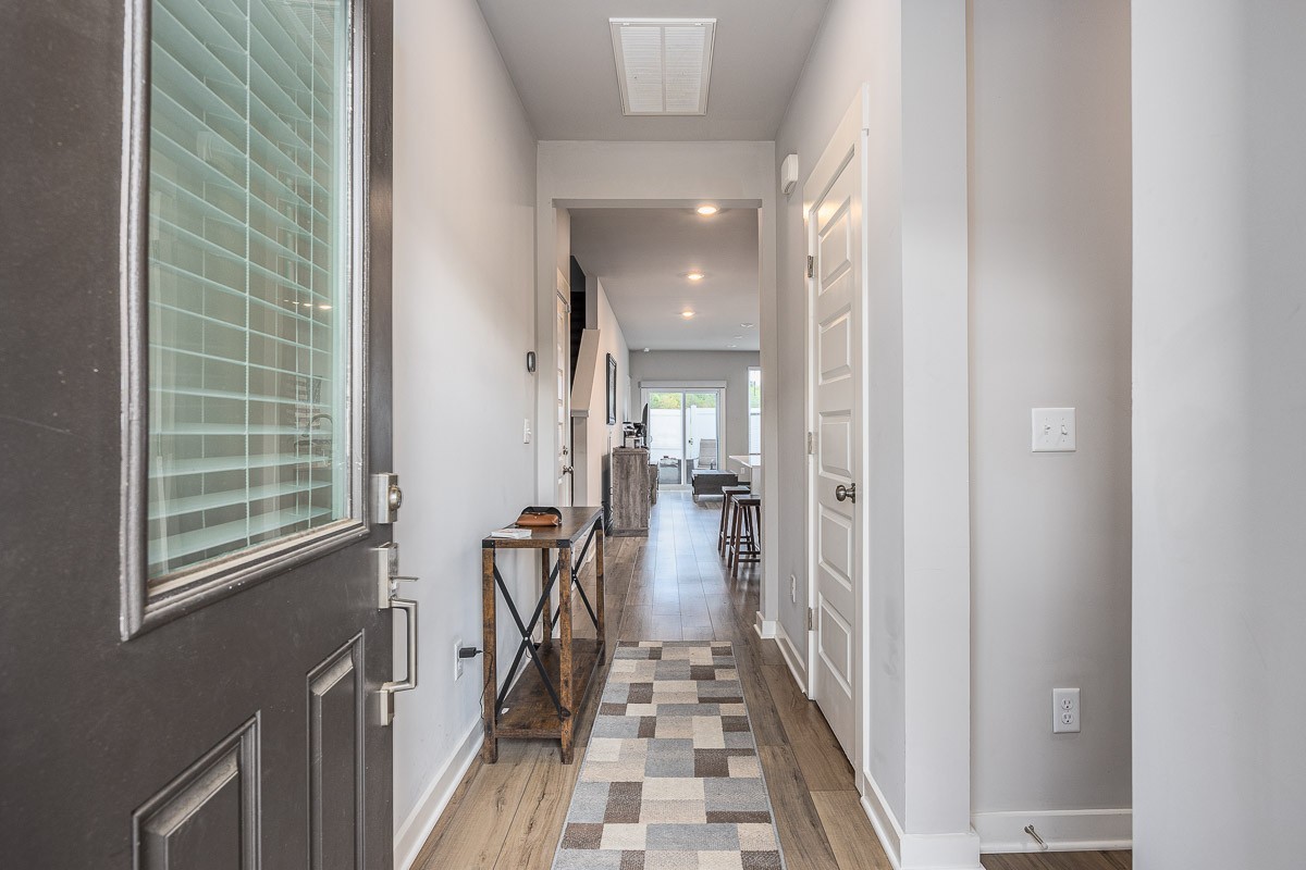 717 Mickelson Way Lebanon, TN 37087 - Photo 2 of 28 a view of a hallway with wooden floor and a bathroom