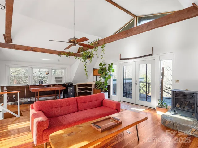 a living room with furniture a ceiling fan and a window