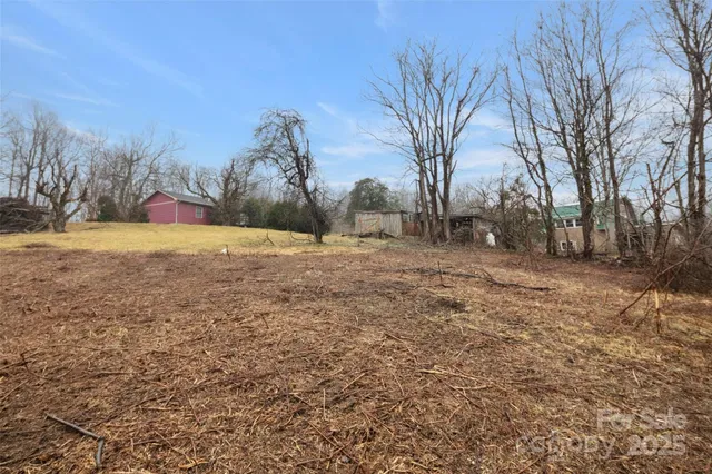 a backyard of a house with large trees