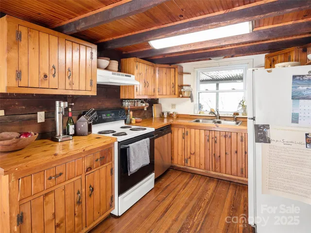 a kitchen with stainless steel appliances granite countertop wooden cabinets a sink and a stove