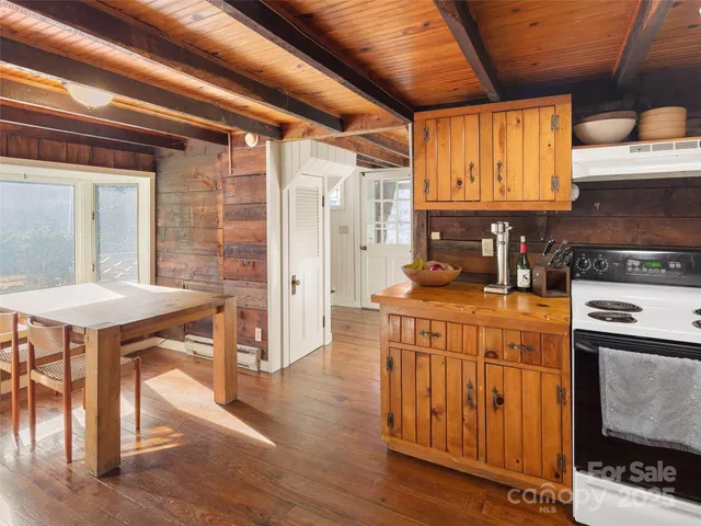 a kitchen with stainless steel appliances granite countertop a stove a sink dishwasher and cabinets with wooden floor