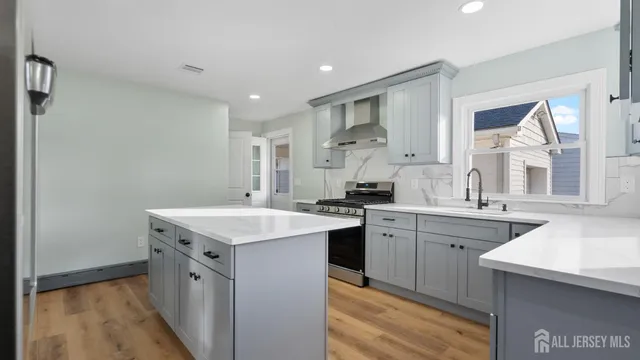 a kitchen with a sink stove and cabinets