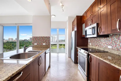 a kitchen that has a sink and a stove