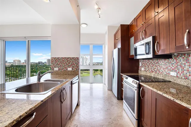 a kitchen that has a sink and a stove