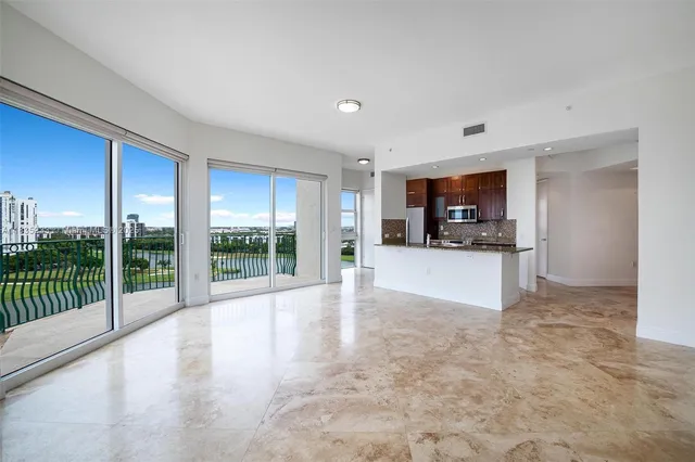 a view of a kitchen with a sink and a living room