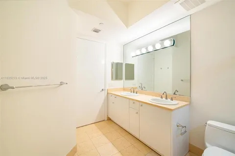 an empty room with a ceiling fan and window