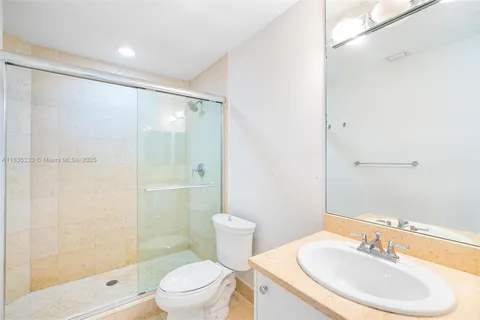 an aerial view of a city with lots of residential buildings ocean and mountain view in back