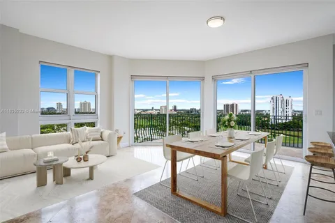 a living room with furniture and a floor to ceiling window