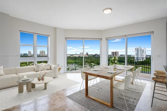 a living room with furniture and a floor to ceiling window